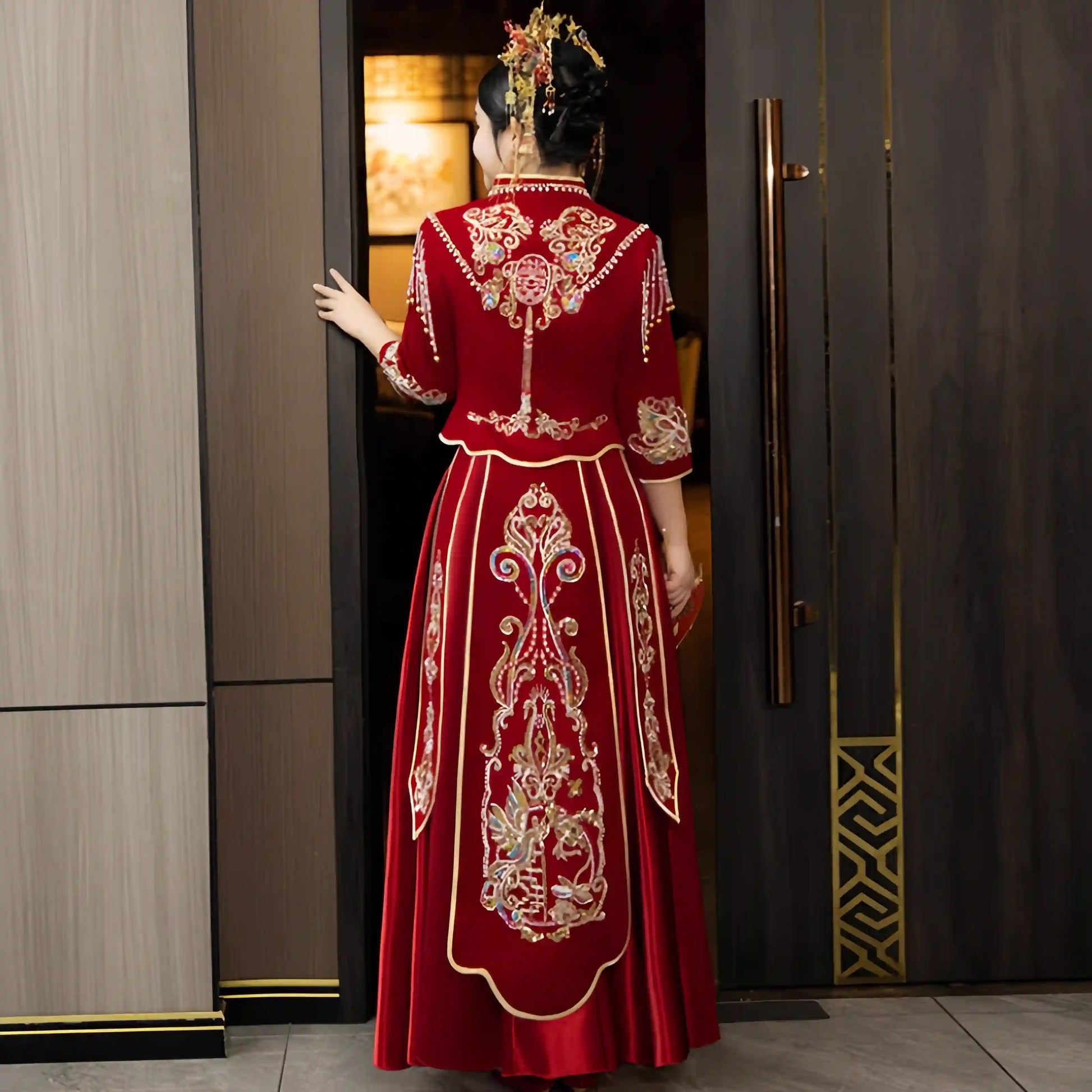 Person wearing a  Modern Red Qun Kwa / Xiuhe Chinese Wedding Gown  in an indoor setting.