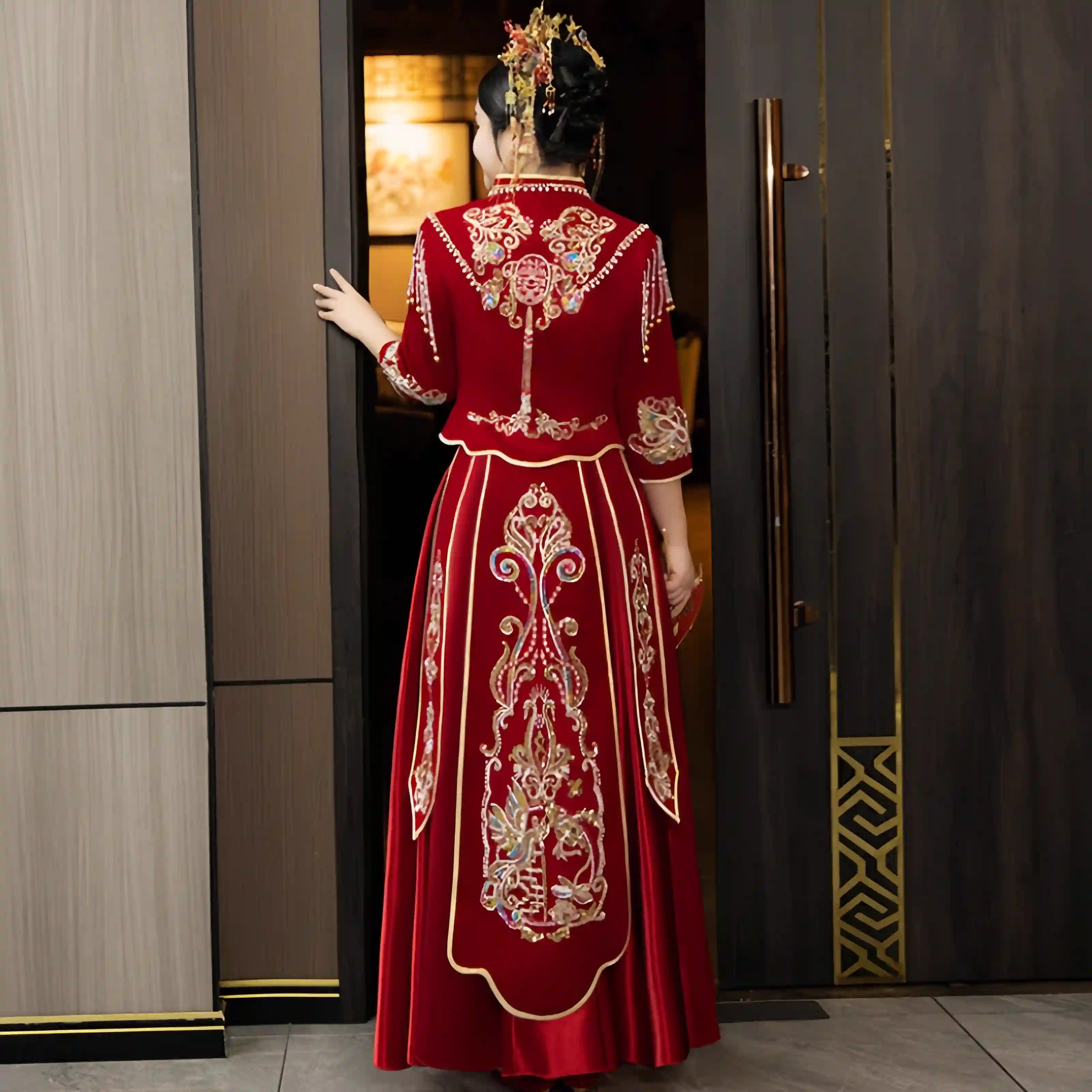 Person wearing a  Modern Red Qun Kwa / Xiuhe Chinese Wedding Gown  in an indoor setting.