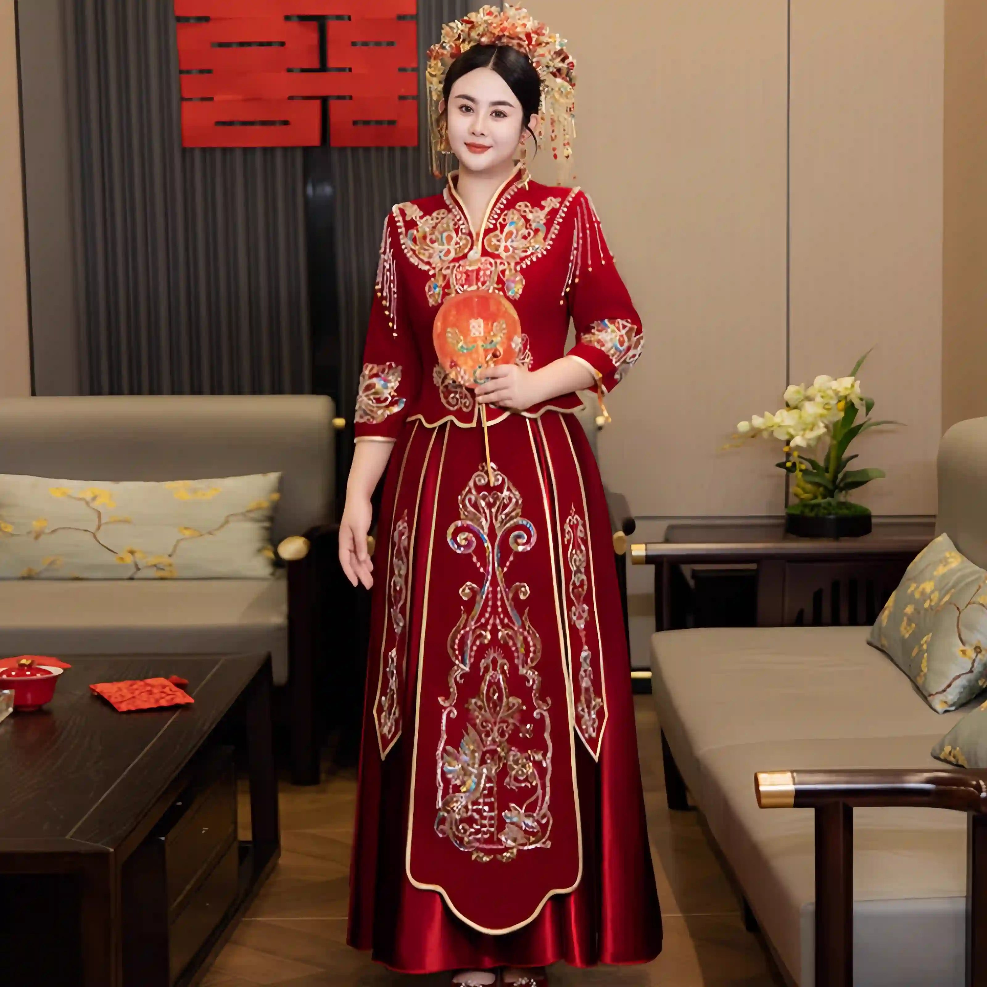 Woman in a plus size  Modern Red Qun Kwa / Xiuhe Chinese Wedding Gown standing in a living room.