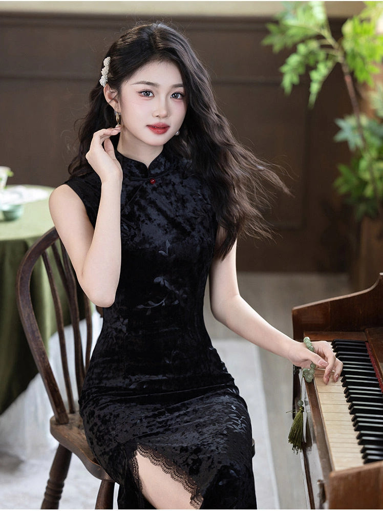 A woman wearing a black velvet modern qipao cheongsam dress sits on a wooden chair next to a piano in an indoor setting.