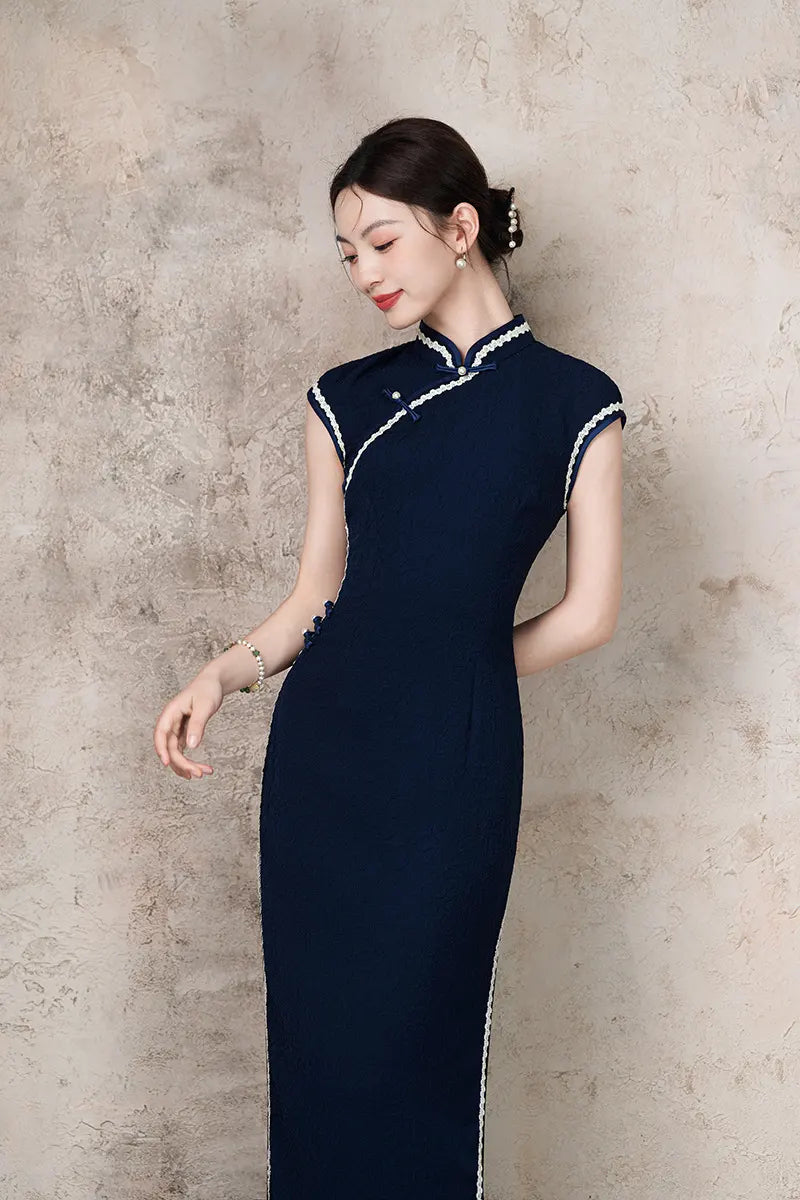 Woman wearing a Navy Blue Cap Sleeves Jacquard Cotton Qi pao Cheongsam Dress with white trim against a plain background