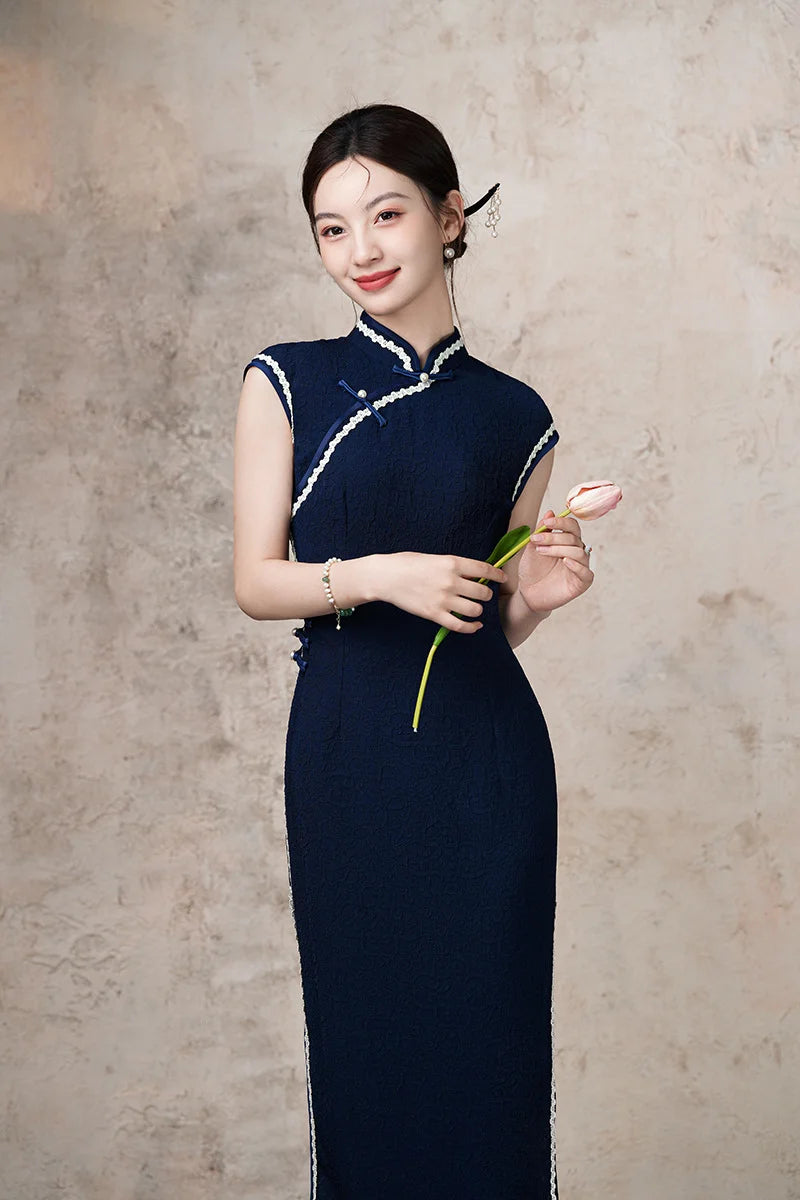 Woman in a Navy Blue Cap Sleeves Jacquard Cotton Qipao Dress  holding a flower against a plain background