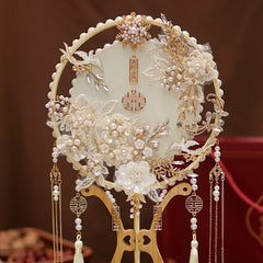 Traditional Ivory White and Golden Chinese Bridal Hand Fan adorned with ornate white lace floral patterns, gold details, delicate pearl accents and ascading tassels