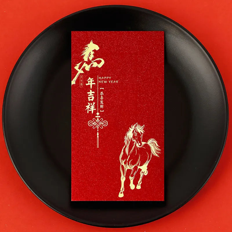 Red envelope with horse design and 'Happy New Year' text on a black plate against a red background