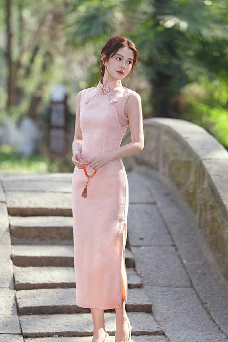 Woman in a pink traditional  Sleeveless Modern Jacquard Qipao dress standing on stone steps with greenery in the background