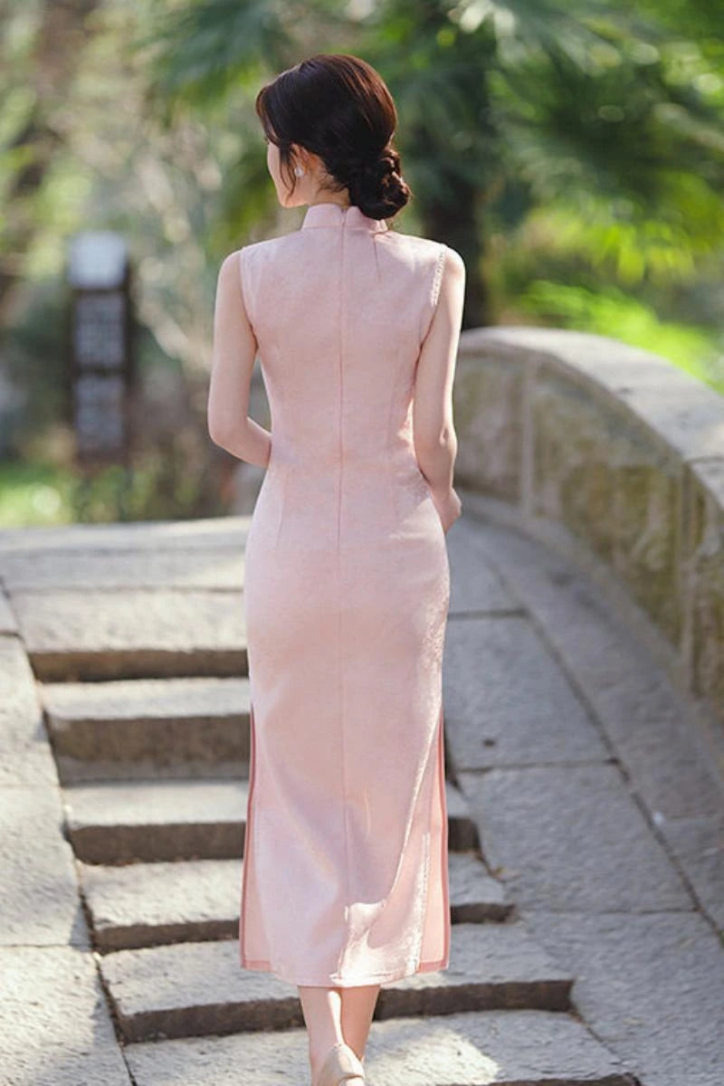 Woman in a Pastel Pink Sleeveless Modern Jacquard Qipaodress standing on stone steps with greenery in the background