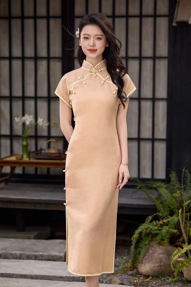 Woman in a Peach traditional  Song Brocade Full-Opening  Qipao Dress standing in a garden setting.