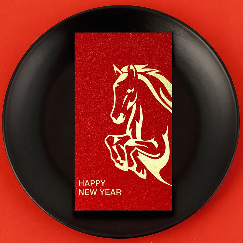 Red card with a horse design and 'Happy New Year' text on a black plate against a red background