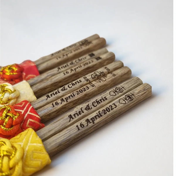 Personalized Chopsticks – Custom Jichimu Wood with Sleeve  and engraved text on a white background
