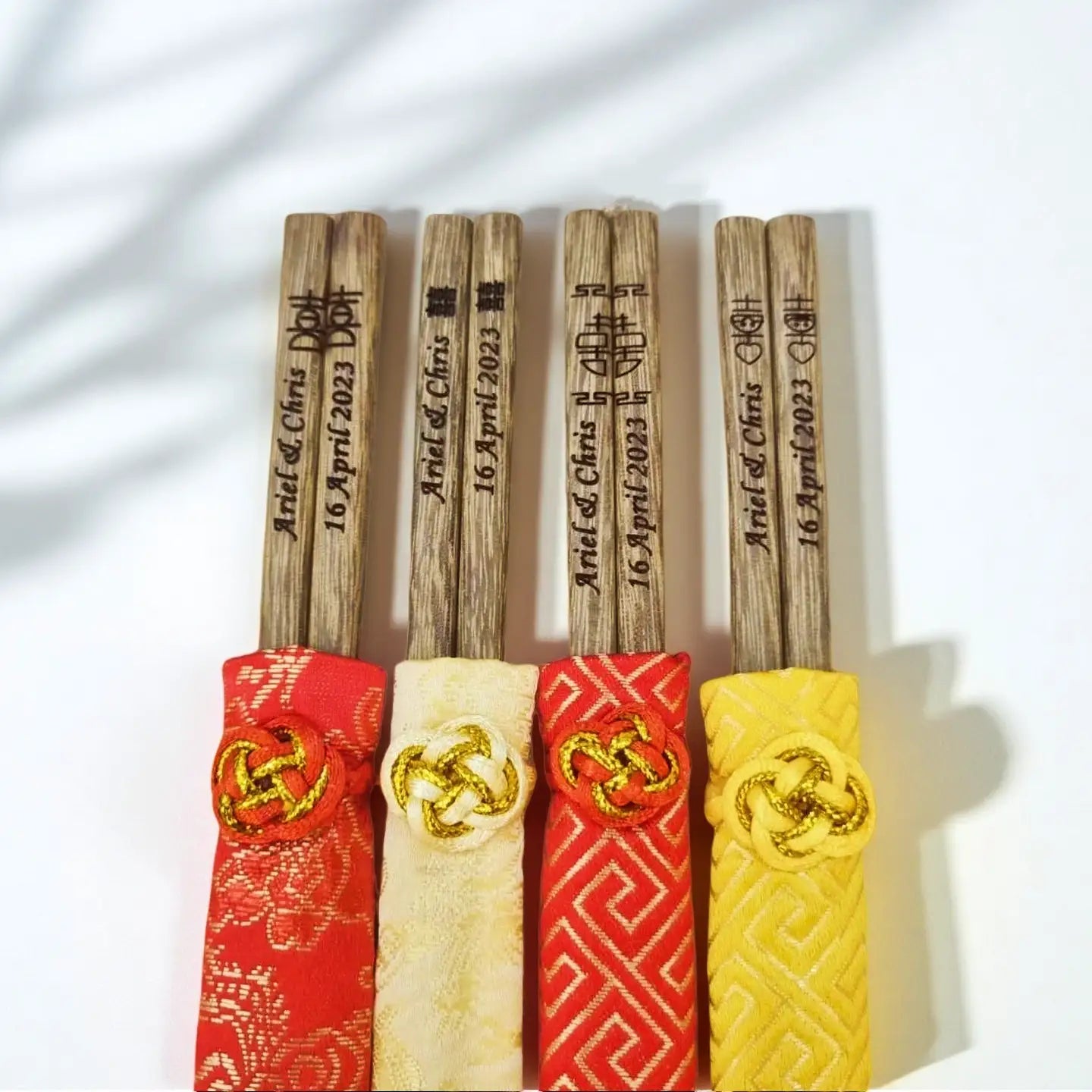 Set of wooden chopsticks with brocade pouch  on a white background