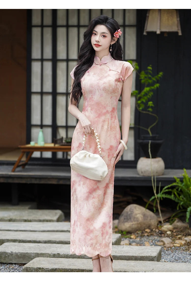 Woman in a Pink Floral Watercolor Long Qipao Dress  standing outdoors with a blurred background
