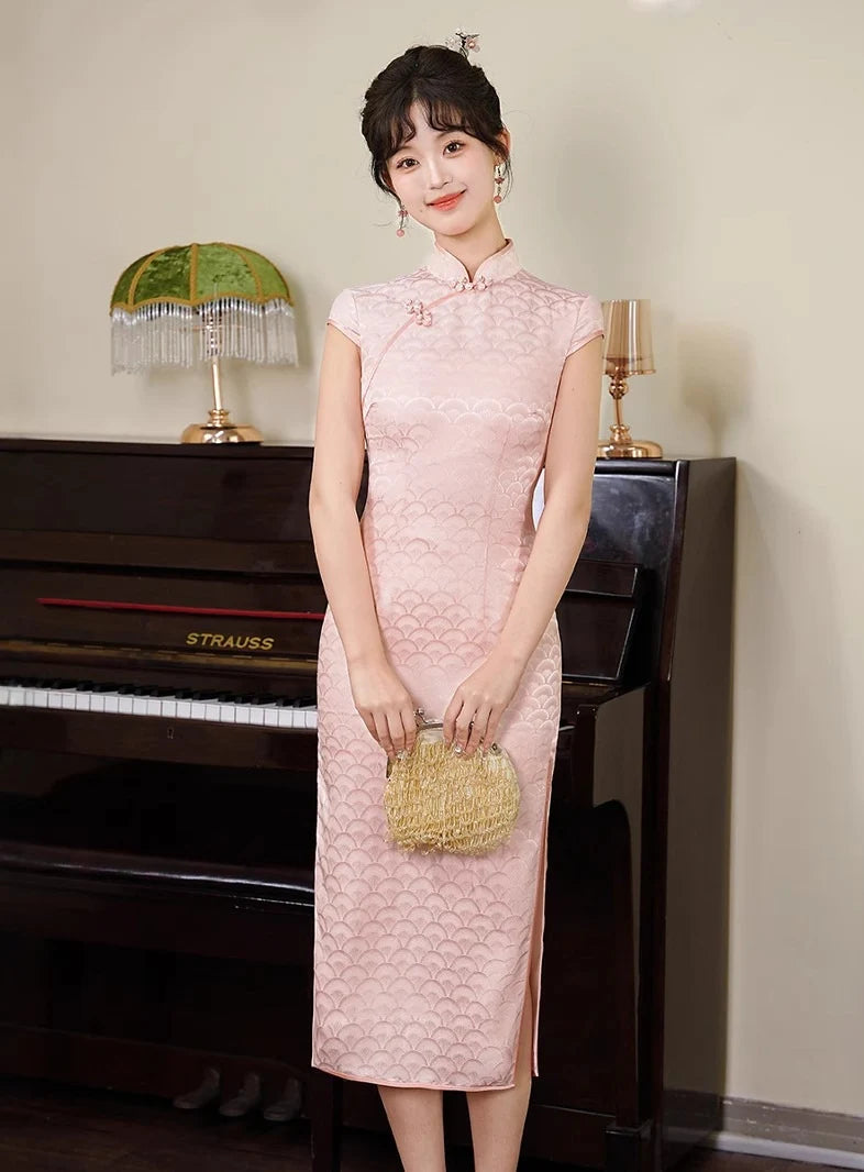 Woman in a Pink Mulberry Silk Jacquard Qipao Dress  holding a small bag in front of a piano
