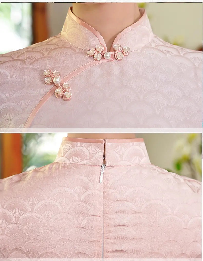 Close-up of a pink traditional garment with decorative buttons and quilted texture.