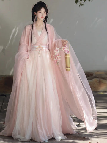 Woman in a Pink Traditional Wei-Jin Style Double-Layer Hanfu Dress Set dress holding flowers indoors.