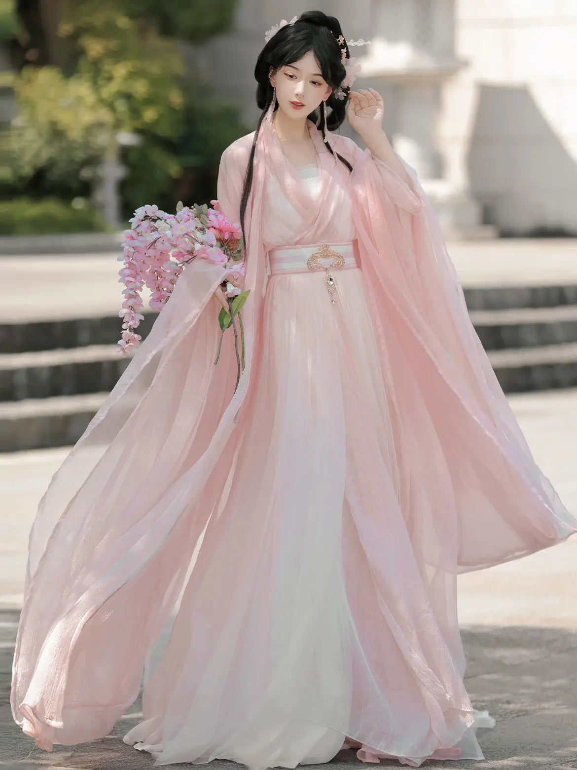 Woman in aPink Traditional Wei-Jin Style Double-Layer Hanfu Dress Set holding flowers outdoors.