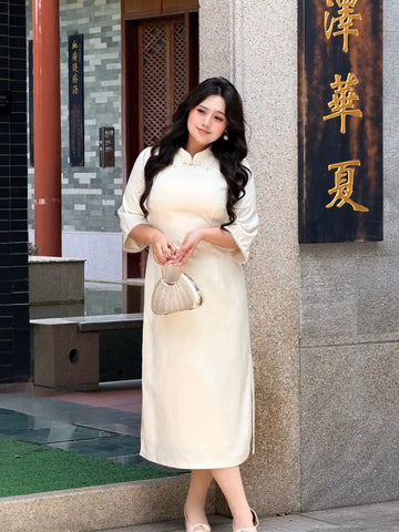 Woman in aPlus Size Ivory White Floral Long Sleeve Jacquard Qipao dress standing in front of a building with Chinese characters.