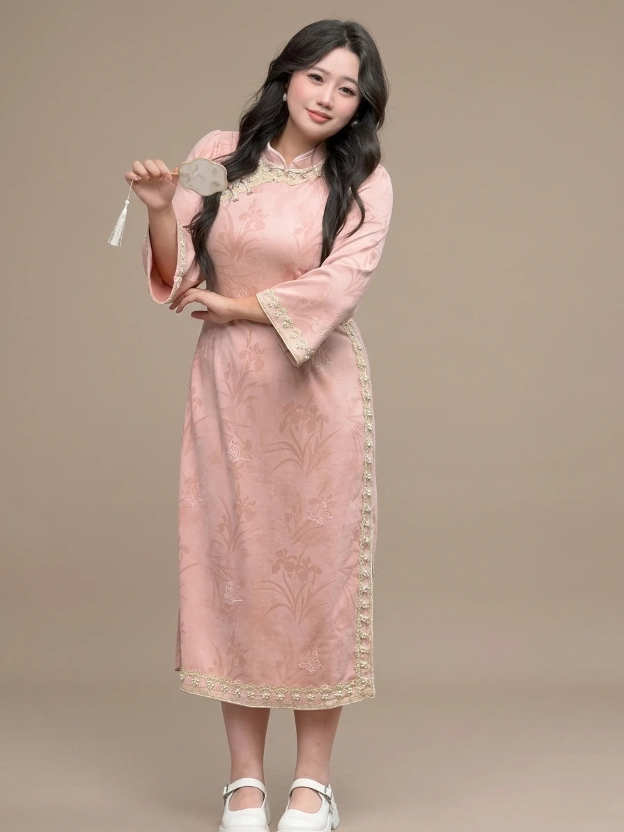 Woman wearing a Plus Size Long Sleeve Pink Floral Qipao with Pearl Trim  on a beige background