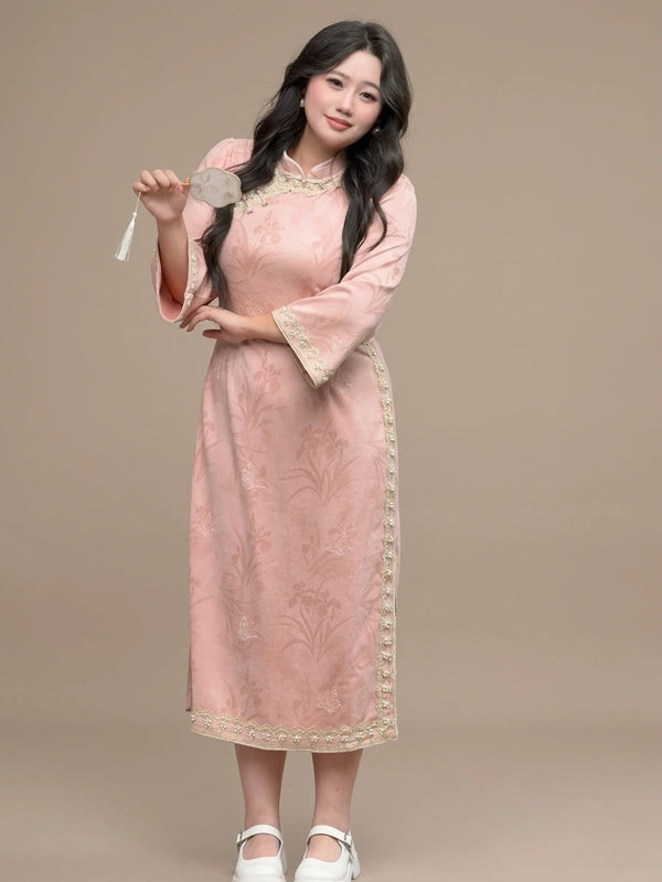 Woman wearing a Plus Size Long Sleeve Pink Floral Qipao with Pearl Trim  on a beige background