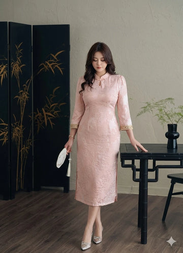 Woman in a Plus Size Modern Pink Long Sleeve Jacquard Qipao cheongsam dress standing in a room with a black screen and table.