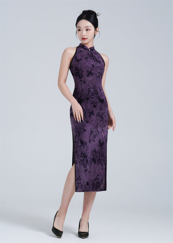 A woman wearing a purple halter neck velvet Qipao with butterfly print.