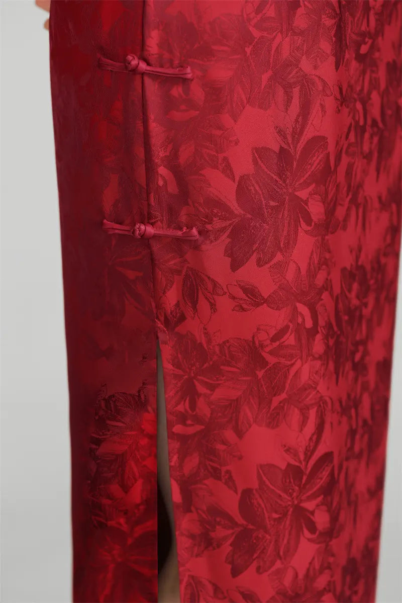 Red floral patterned pants on a plain background