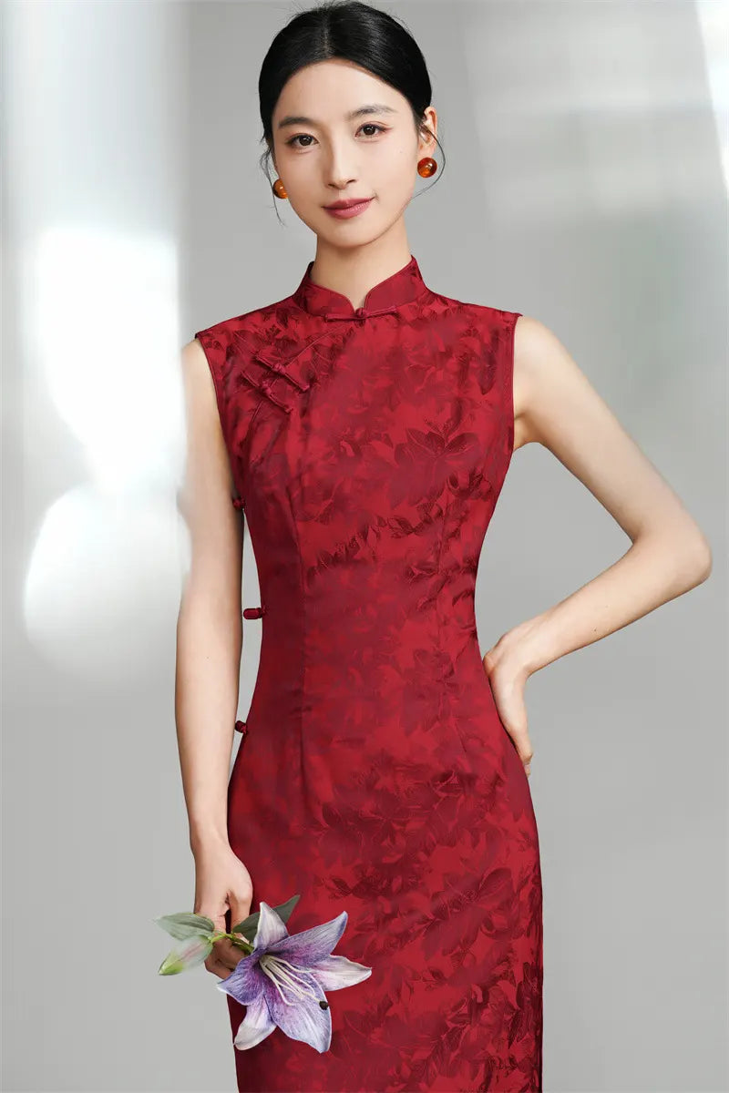 A Chinese woman wear a qipao  with floral details against a gray background