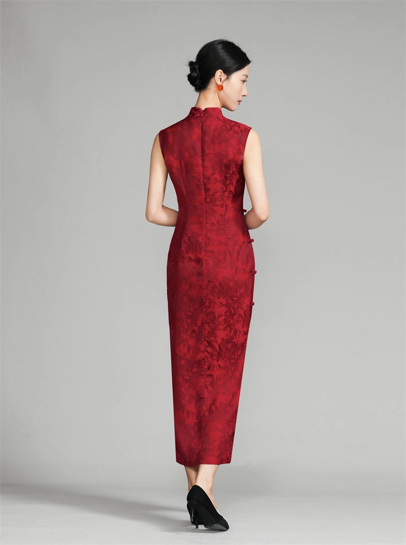 Woman wearing a red modern cheongsam against a gray background