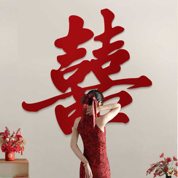 Woman in a red dress standing behind large Red Calligraphy Style Double Happiness Wall Sign on a beige wall.