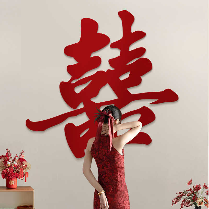 Woman in a red dress standing behind large Red Calligraphy Style Double Happiness Wall Sign on a beige wall.