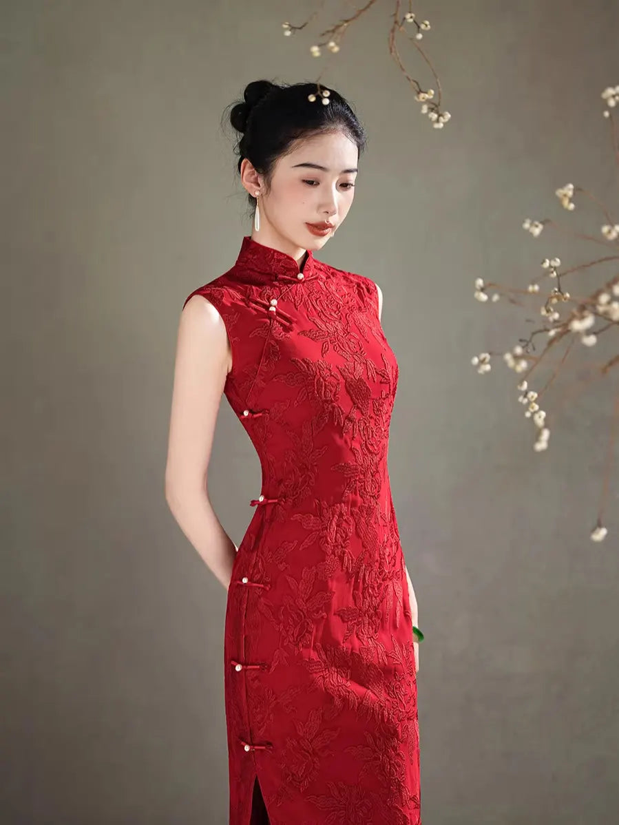Woman wearing a  traditional Red Floral Embroidery Sleeveless Qipao dress against a neutral background