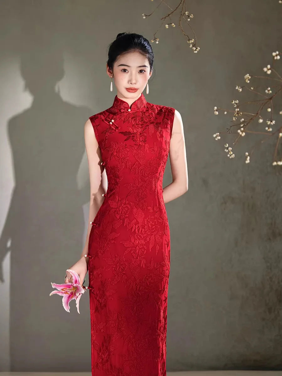 Woman in a red lace Floral Embroidery Sleeveless Qipao dress holding a pink flower against a plain background