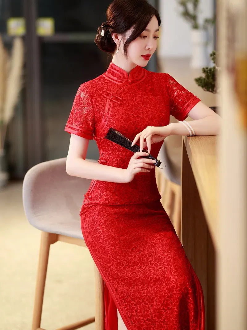 Woman in a Red Floral Lace Midi Qipao Cheongsam Dress holding a hand fan in an indoor setting