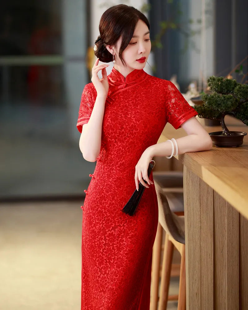 Woman in a Red Floral Lace Midi Qipao Cheongsam Dress  standing indoors with a blurred background