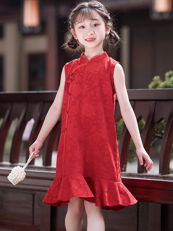 A young girl with braided hair wearing a Red Floral Summer Sleeveless Qipao Cheongsam Dress for Girls  dress with a high collar and front buttons, standing in front of a dark wooden railing.