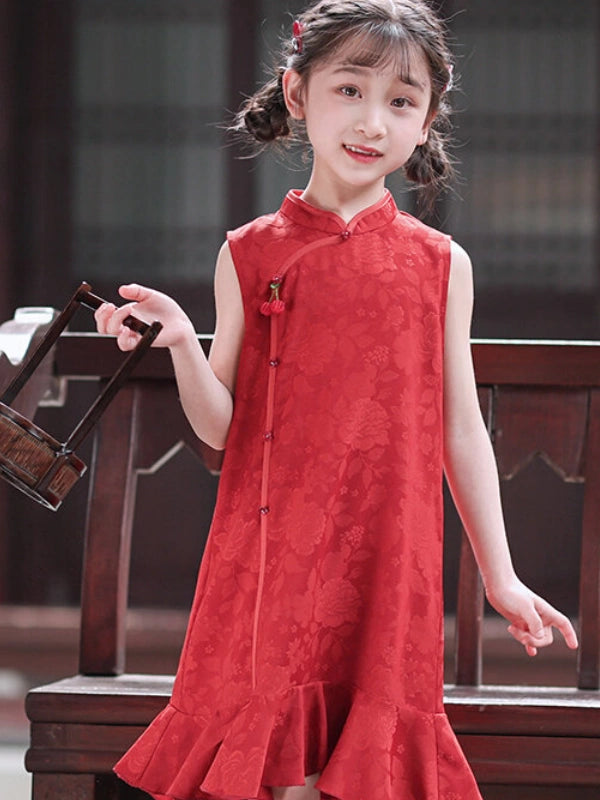 A young girl with braided pigtails wearing a sleeveless red floral-patterned qipao cheongsam  dress with a high collar and front buttons, standing in front of a dark wooden bench.