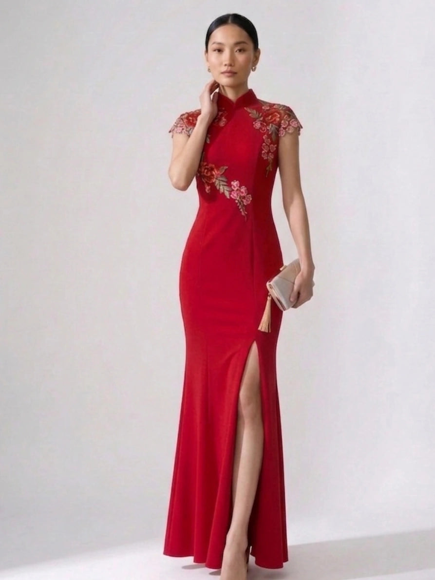 Woman wearing a Red Floral Thigh-High Slit Floor Length Mermaid Qipao cheongsam bridal gown with floral embroidery on a white background