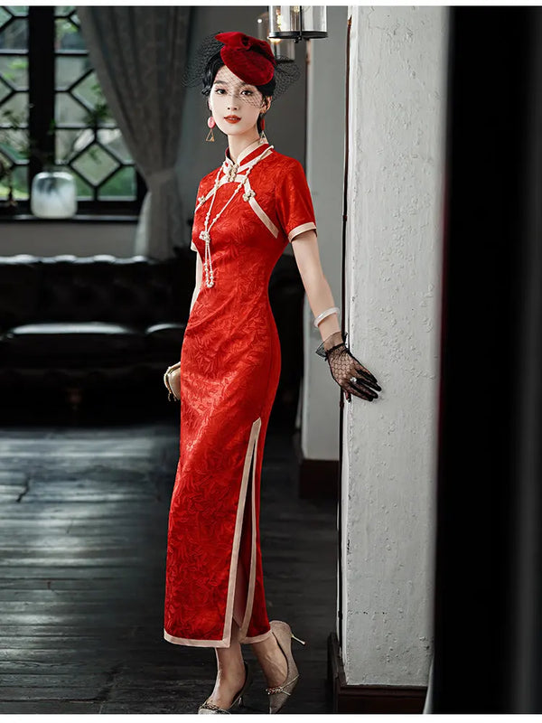 Woman in aRed & Gold Foral Jacquard Qipao - Chinese Wedding Tea Ceremony Dress  standing indoors.