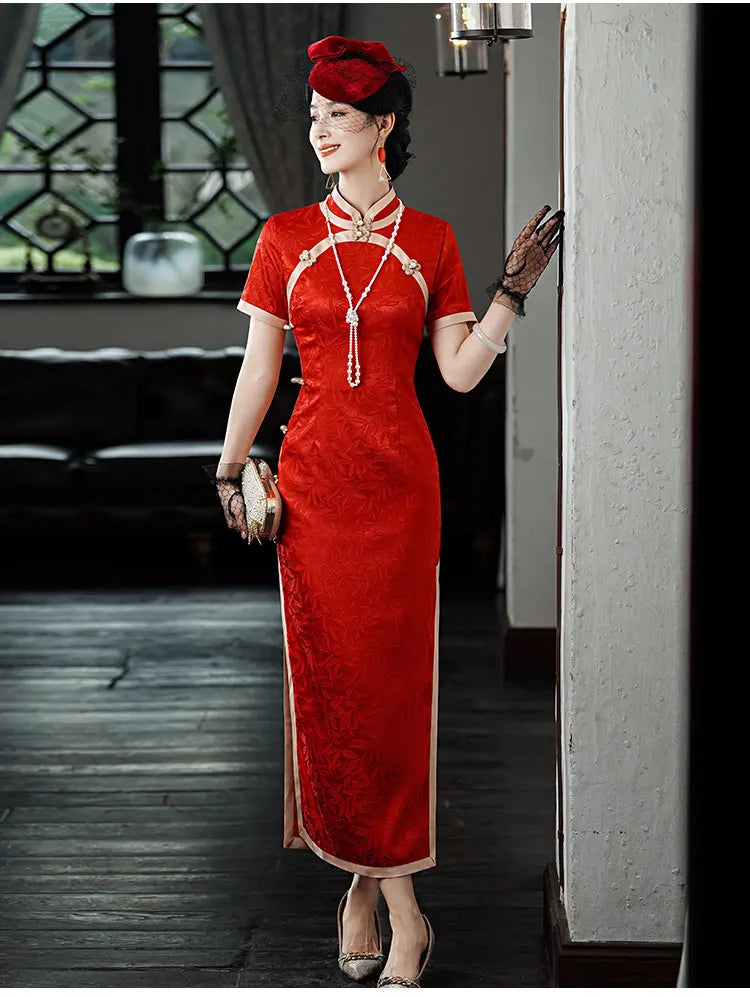Woman in Red & Gold Foral Jacquard Qipao - Chinese Wedding Tea Ceremony Dress  with a matching hat standing indoors.
