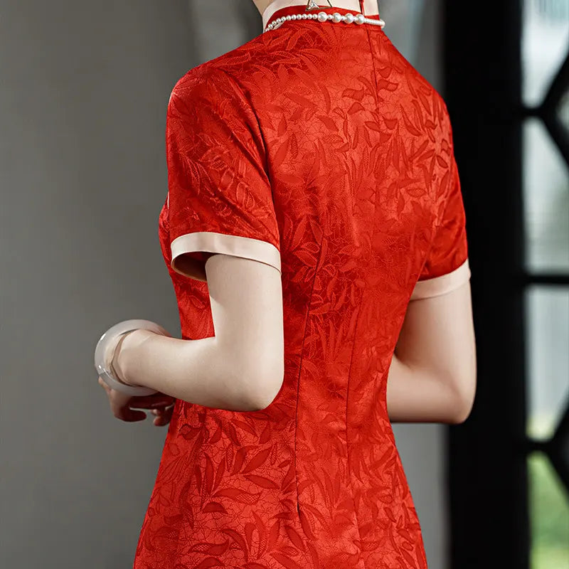 Red floral dress worn by a person with a blurred background