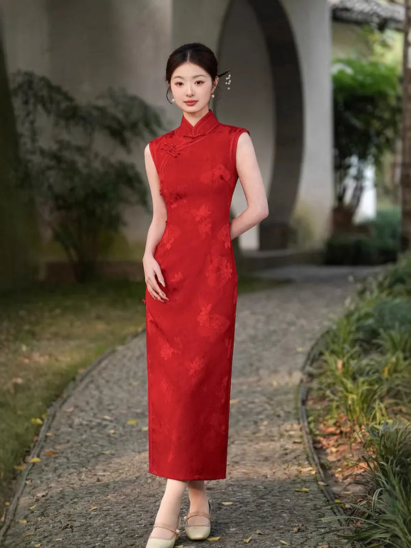 Woman in a Red Chinese Jacquard Sleeveless Modern Qipao Dress standing outdoors on a path with greenery.