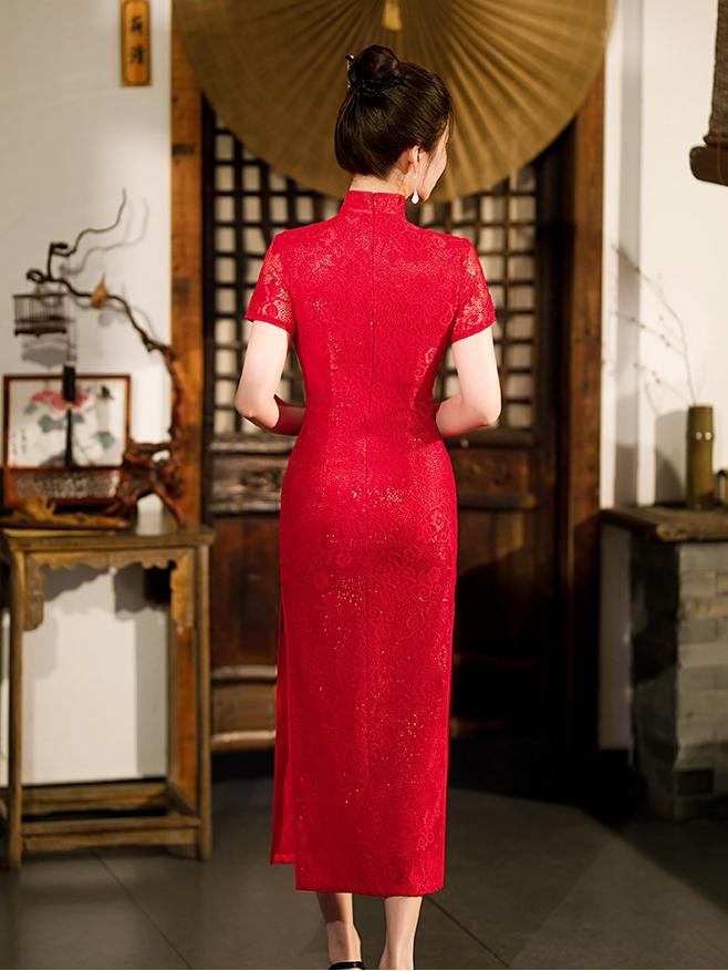 Woman wearing a Red Lace Midi Length Short Sleeves cheongsam Dress  in an indoor setting with wooden furniture and decor.