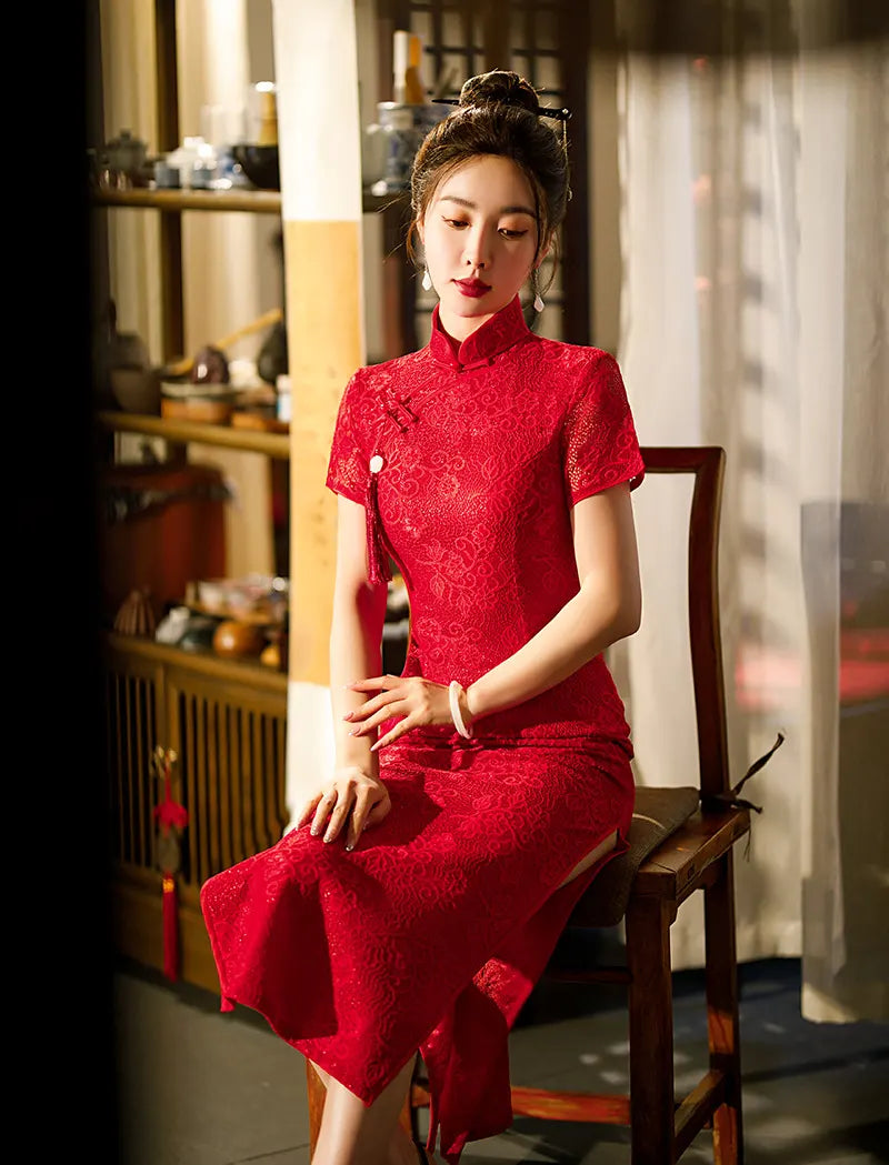 Woman in aRed Lace Midi Length Short Sleeves Qipao Dress  sitting on a wooden chair in a traditional setting