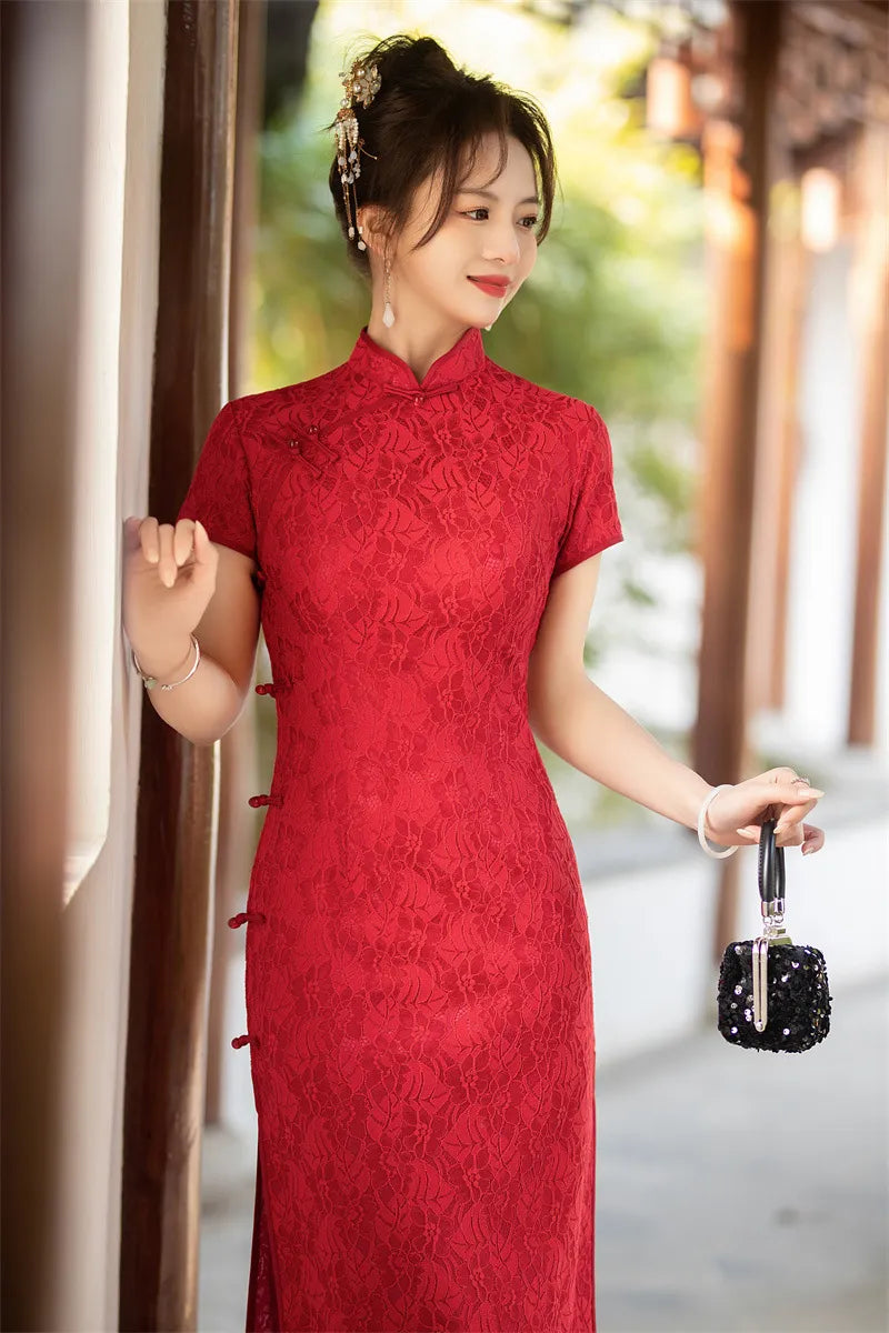 Woman in a red traditional Auspicious Red Lace Qipao standing outdoors with blurred background