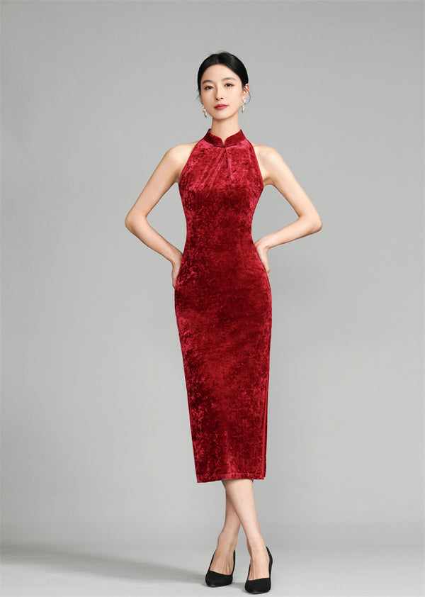 A woman wearing a red halter neck velvet Qipao with a figure-hugging silhouette.