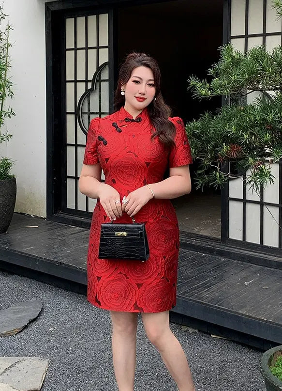 Woman in a Red Plus Size Modern Rose Jacquard new chinese style Qipao holding a black handbag in front of a building entrance.