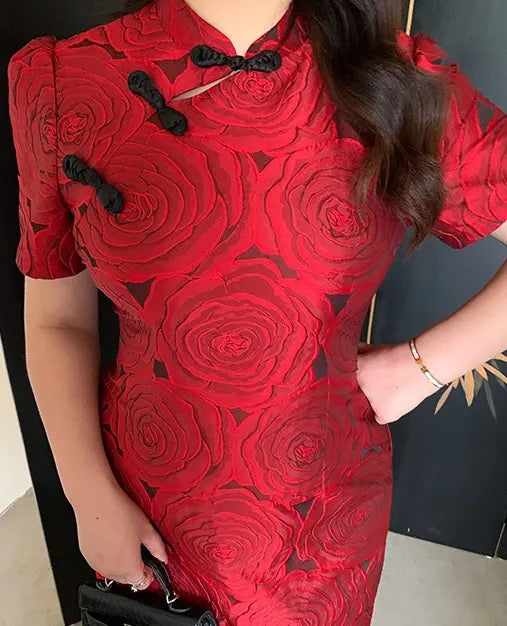 Red Plus Size Modern Rose Jacquard Qipao dress with black details worn by a person, against a dark background.