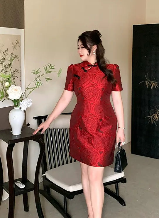 Woman in a Red Plus Size Modern Rose Jacquard Qipao  dress standing in a room with a vase and chair.