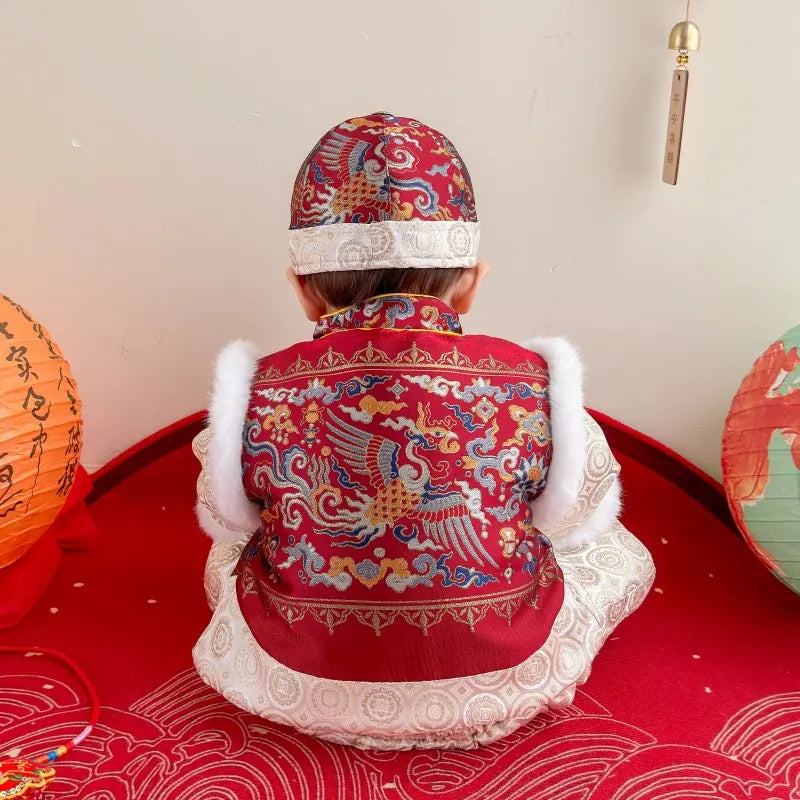 Child wearing a traditional Red Quilted Chinese Baby Winter Tang Suit Set outfit with a red background