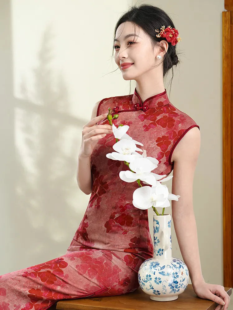 Woman in a Red Sleeveless Floral Qipao Dress – Modern Chinese Cheongsam  holding white flowers next to a vase.