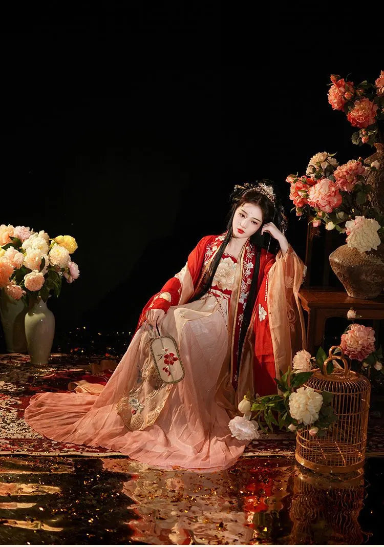 A chinese woman in hanfu cosplay costume surrounded by flowers and decorative elements on a dark background